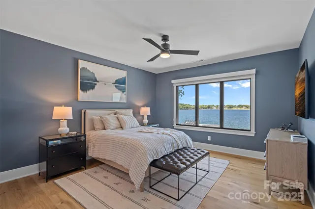 a spacious bedroom with a bed and a flat screen tv