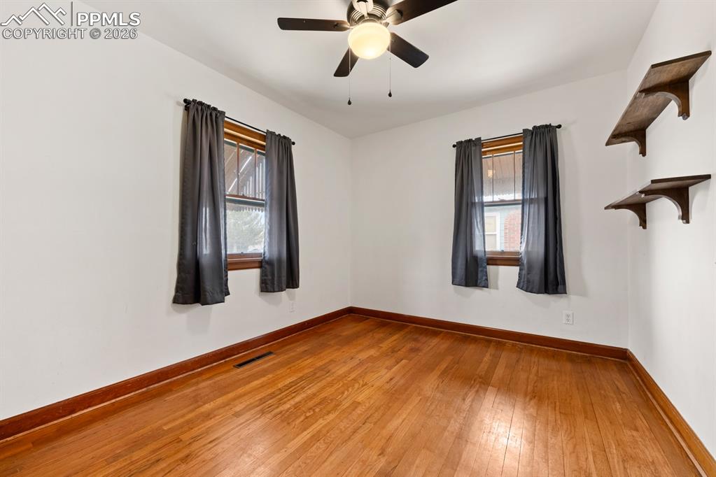 522 Madison Street Pueblo, CO 81004 - Photo 13 of 33 a view of an empty room with wooden floor and a window