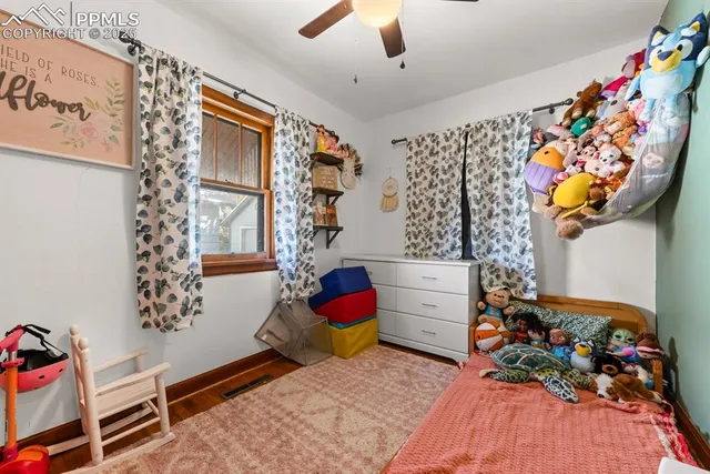 a living room with furniture and baby crib