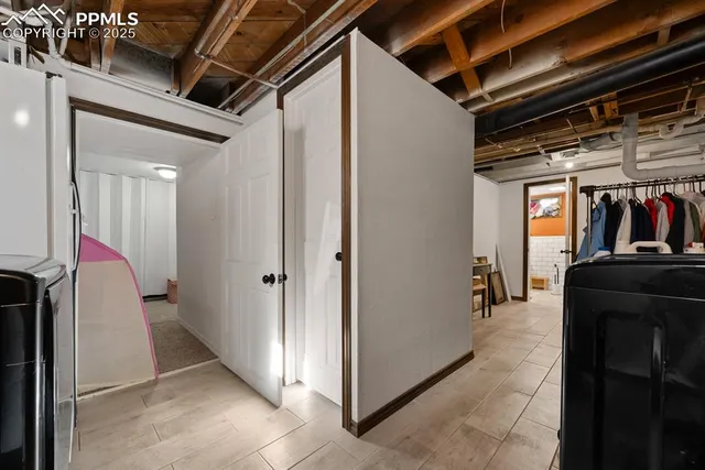 a view of walk in closet with clothes and shoes