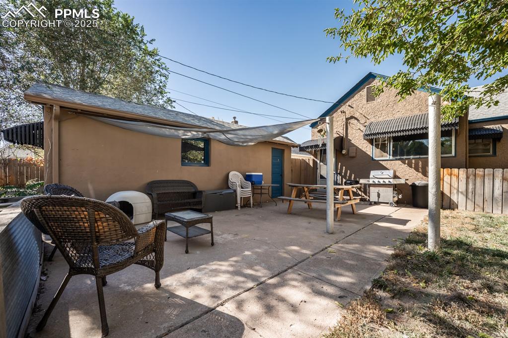 522 Madison Street Pueblo, CO 81004 - Photo 24 of 33 a view of a patio with table and chairs and potted plants