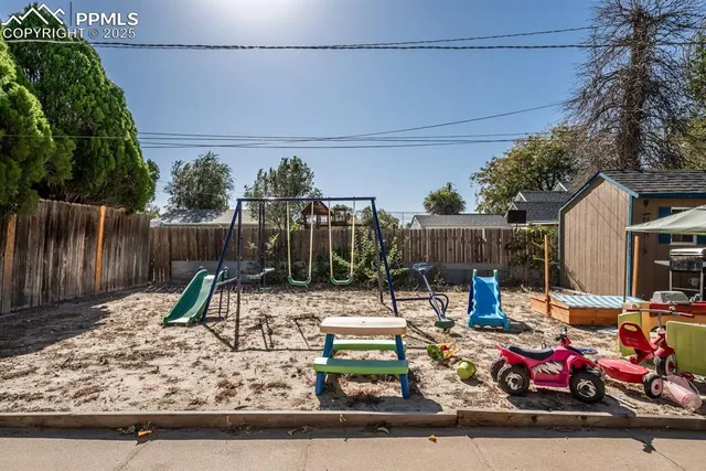 a view of a chair and table and the wooden fence