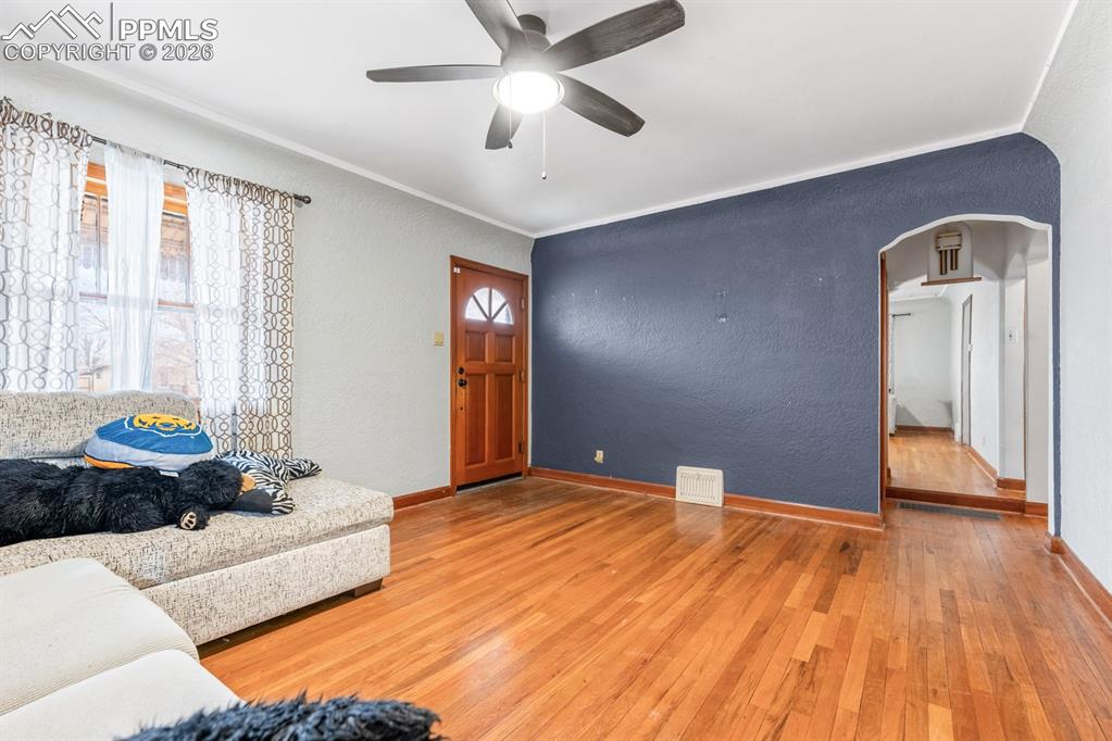 522 Madison Street Pueblo, CO 81004 - Photo 4 of 33 a bedroom with a bed and wooden floor