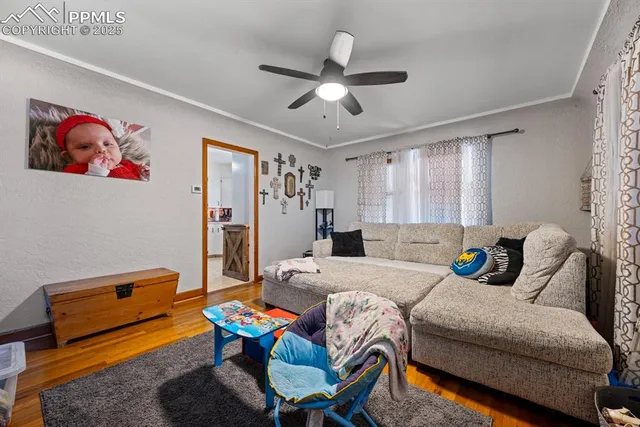 a bedroom with a bed and a flat tv screen on dresser