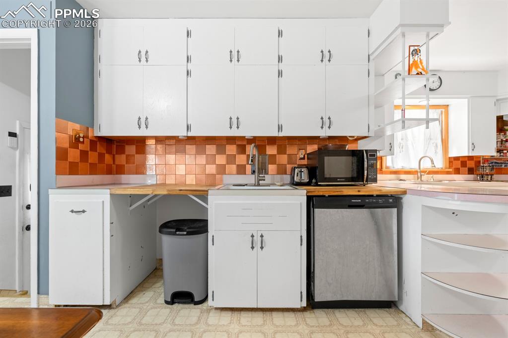 522 Madison Street Pueblo, CO 81004 - Photo 6 of 33 a kitchen with stainless steel appliances granite countertop a sink and a stove