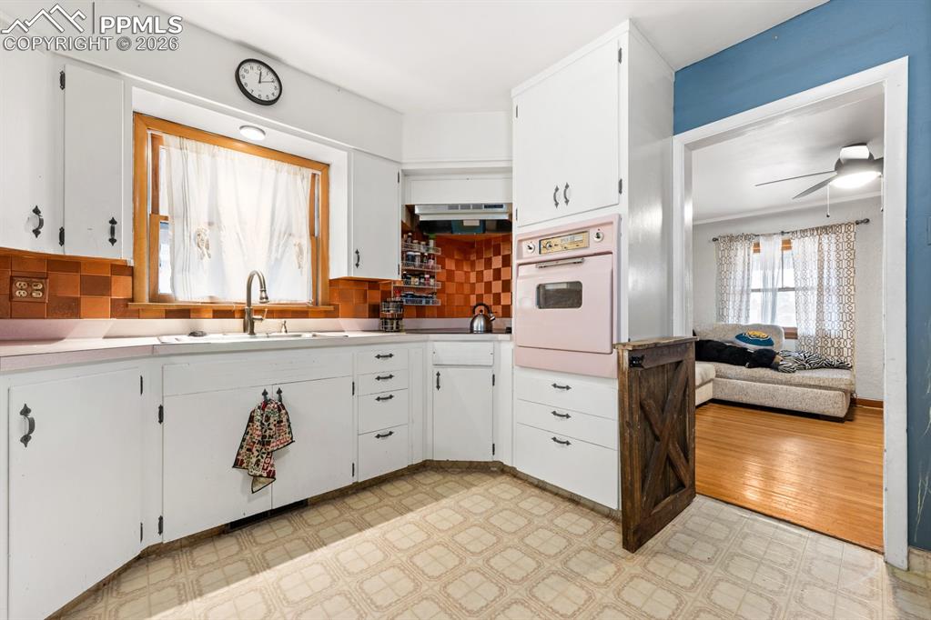522 Madison Street Pueblo, CO 81004 - Photo 7 of 33 a kitchen with stainless steel appliances a stove a sink and a refrigerator