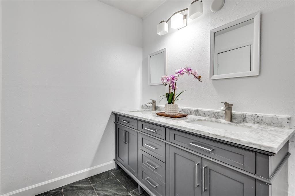 1805 Etain Road Irving, TX 75060 - Photo 11 of 23 a bathroom with a granite countertop sink and a mirror