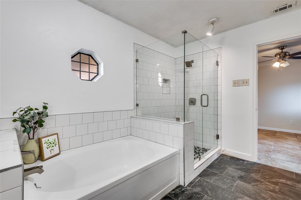 1805 Etain Road Irving, TX 75060 - Photo 13 of 23 a bathroom with a bathtub and a shower