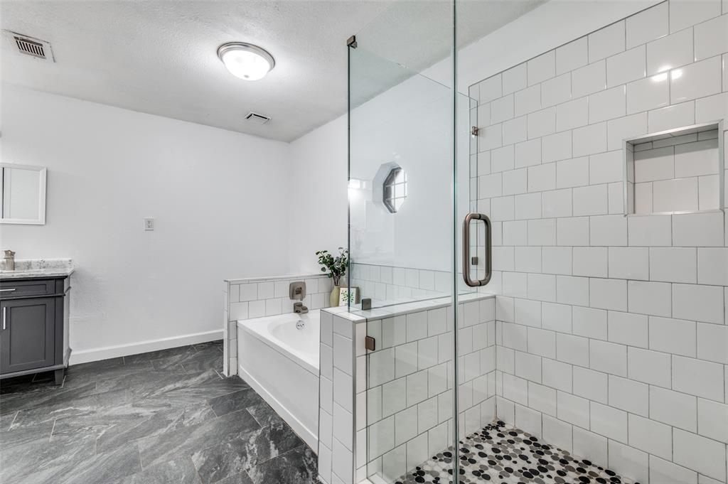 1805 Etain Road Irving, TX 75060 - Photo 14 of 23 a bathroom with a sink a vanity and shower