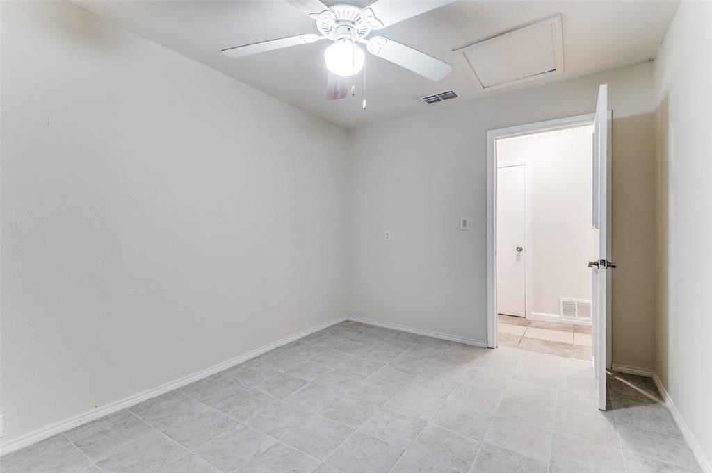 1805 Etain Road Irving, TX 75060 - Photo 15 of 23 an empty room with a ceiling fan and a window