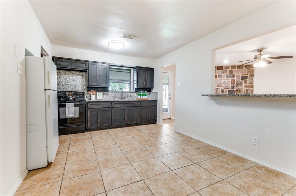 1805 Etain Road Irving, TX 75060 - Photo 3 of 23 a kitchen with stainless steel appliances a refrigerator sink and cabinets