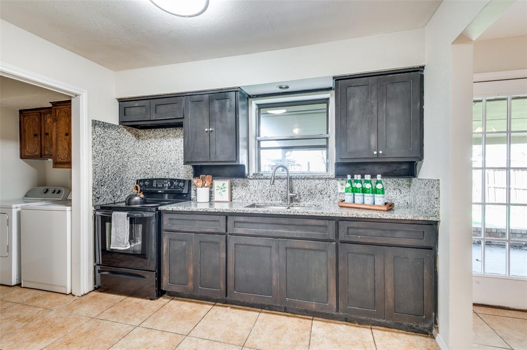 1805 Etain Road Irving, TX 75060 - Photo 4 of 23 a kitchen with stainless steel appliances a sink cabinets and a window