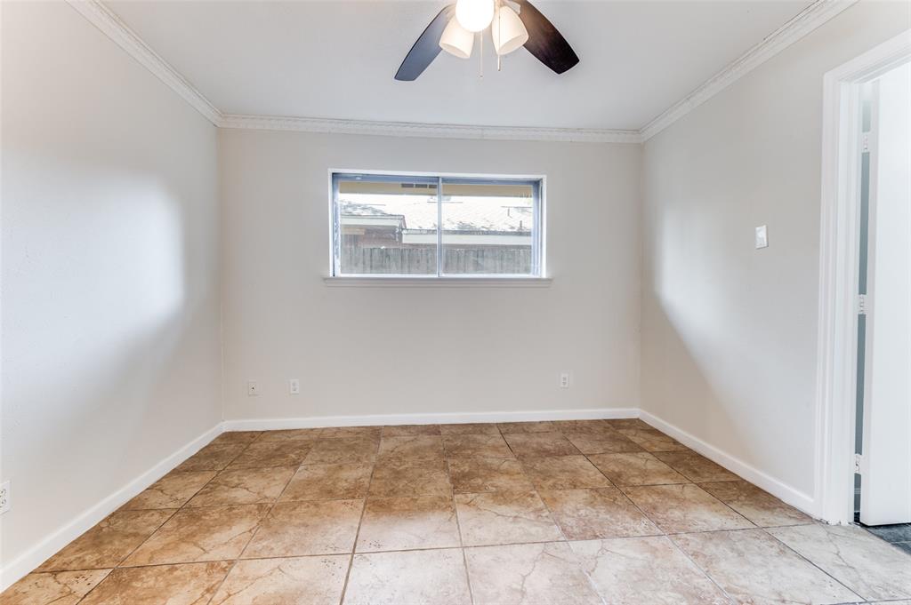 1805 Etain Road Irving, TX 75060 - Photo 10 of 23 an empty room with a ceiling fan and window