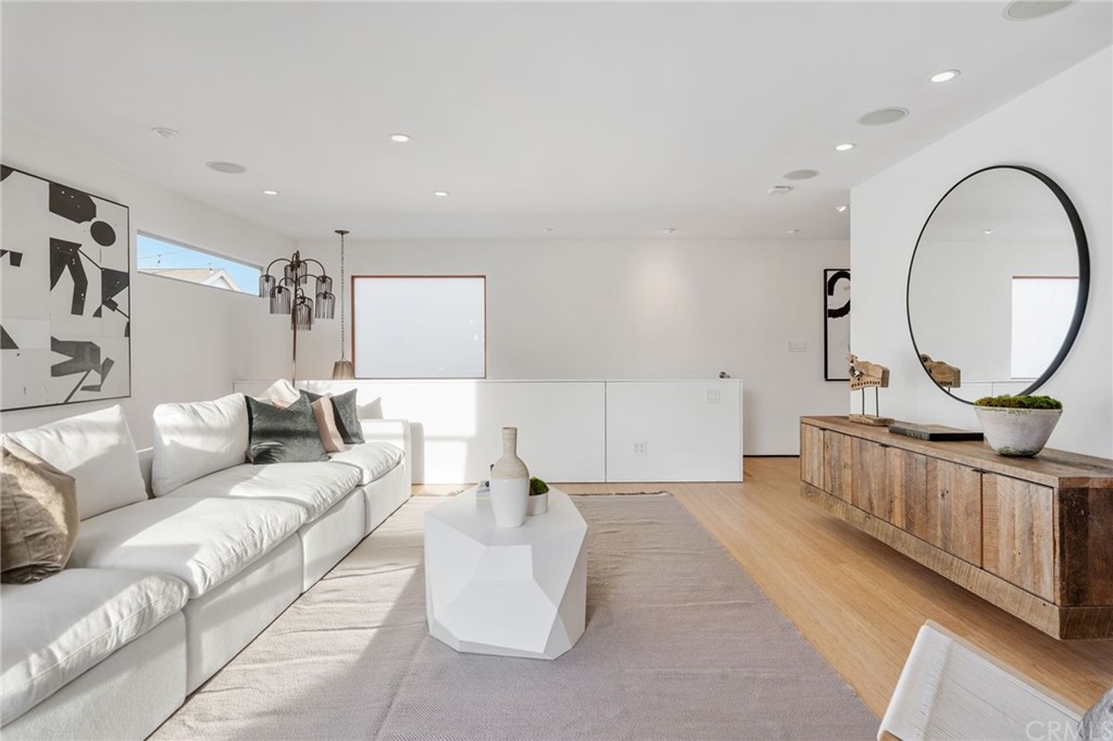 464 34th Street Manhattan Beach, CA 90266 - Photo 33 of 54 a living room with furniture a mirror and a lamp