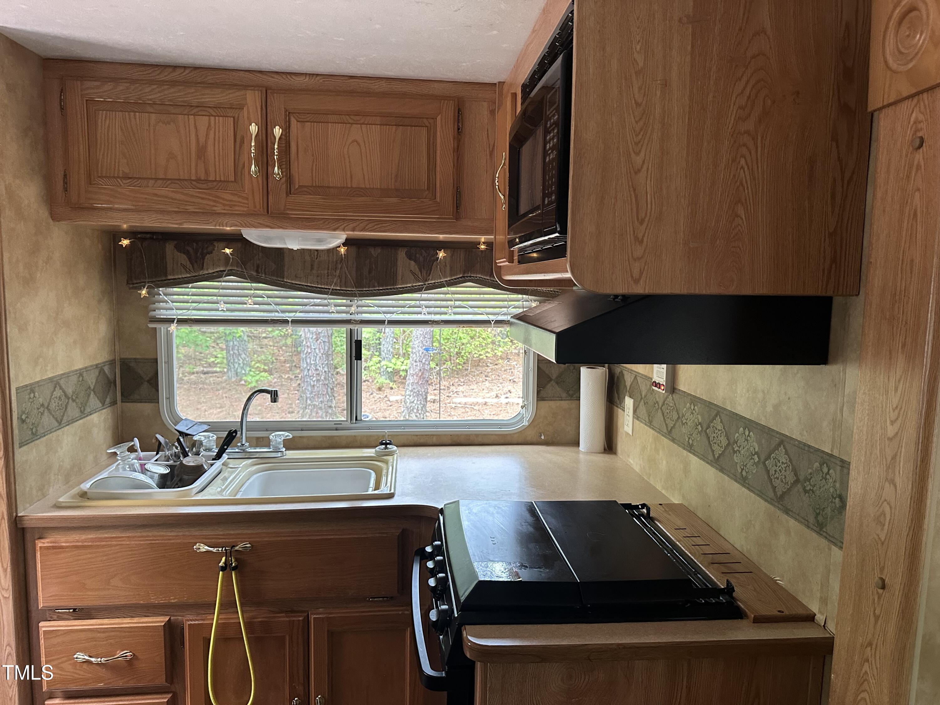 334 Cree Drive Spring Hope, NC 27882 - Photo 3 of 16 a kitchen with a sink and a stove top oven
