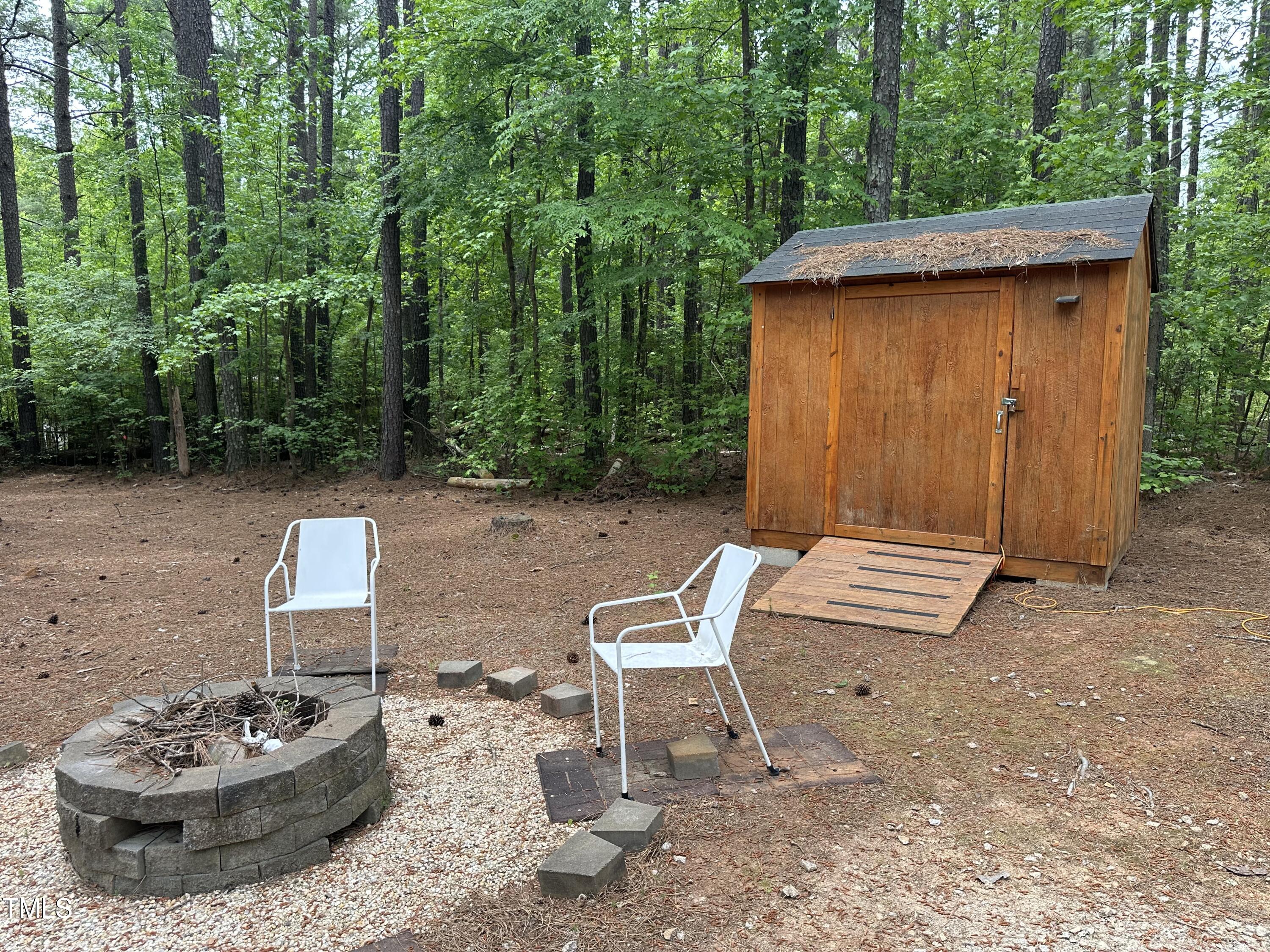 334 Cree Drive Spring Hope, NC 27882 - Photo 4 of 16 a view of a backyard with table and chairs and potted plants