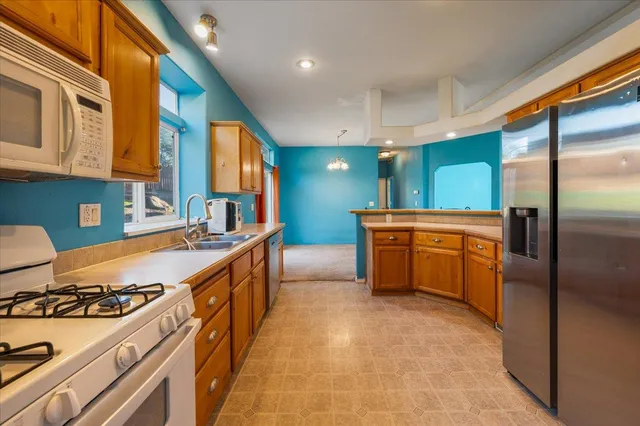 a view of a room that has a large window and wooden floor
