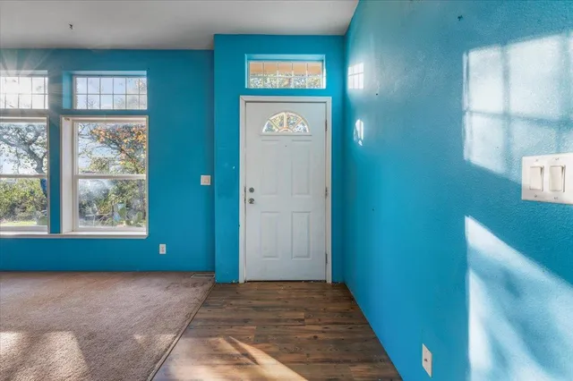 a view of a dining room with furniture and a potted plant