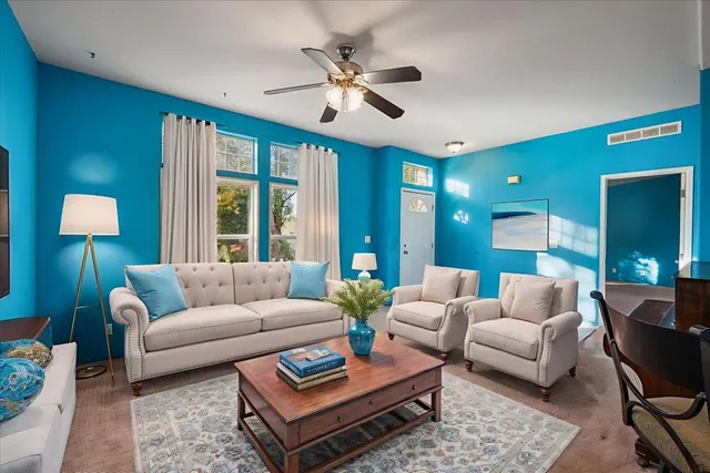 a view of a livingroom with furniture and a ceiling fan