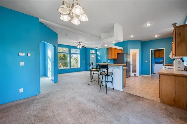 a kitchen with stainless steel appliances granite countertop a stove a sink and a refrigerator