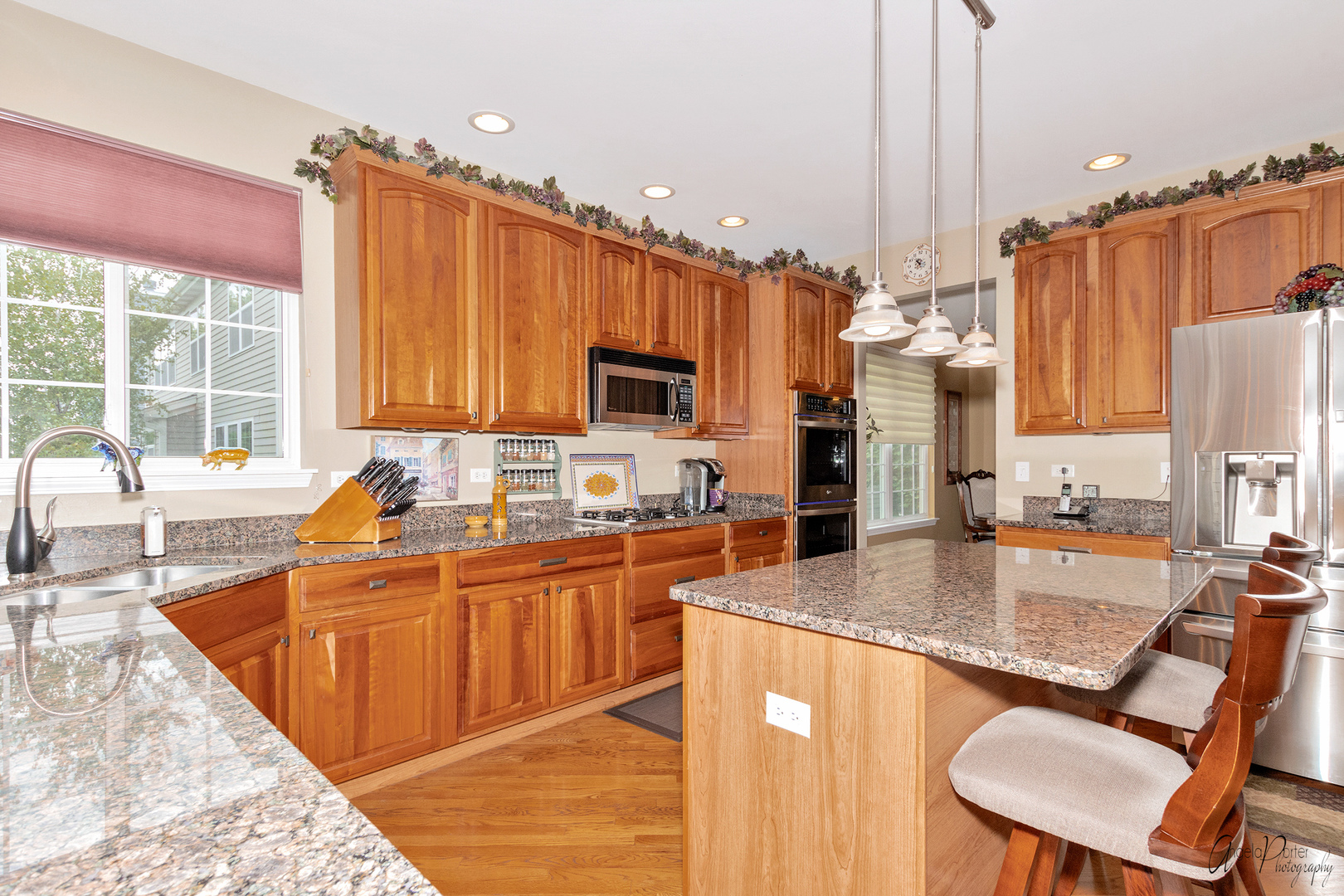 398 Sterling Circle Cary, IL 60013 - Photo 14 of 68 a kitchen with stainless steel appliances granite countertop a sink refrigerator and cabinets