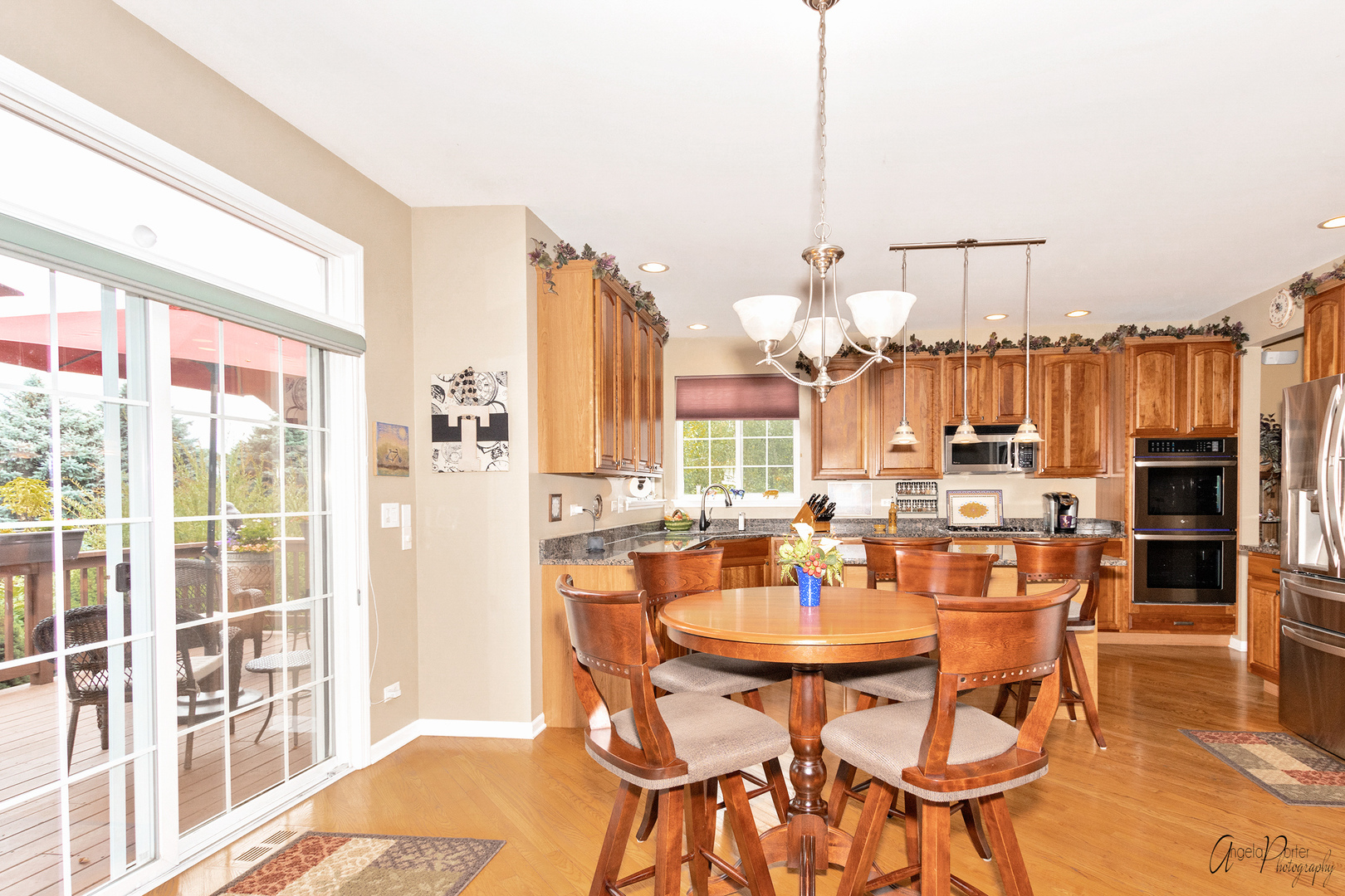 398 Sterling Circle Cary, IL 60013 - Photo 17 of 68 a dining room with furniture a chandelier and wooden floor