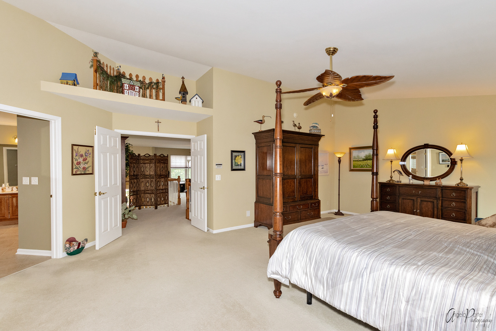 398 Sterling Circle Cary, IL 60013 - Photo 36 of 68 a bedroom with a large bed and a chandelier