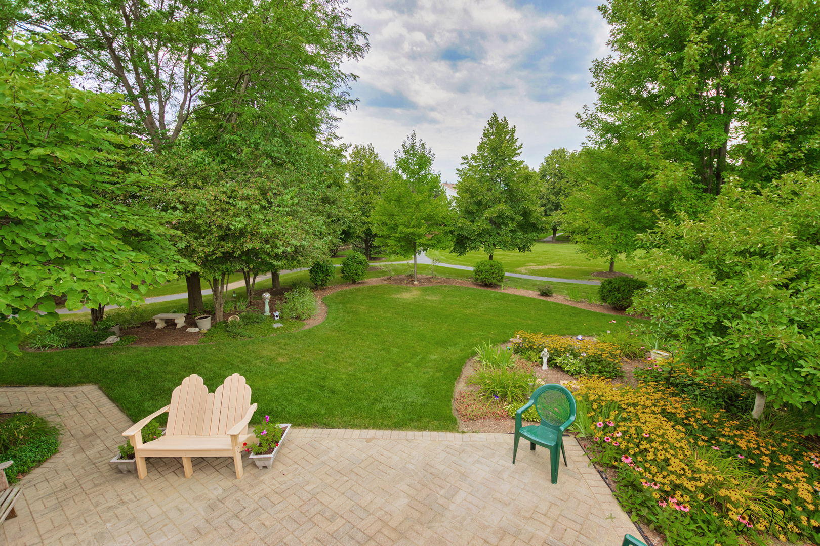 398 Sterling Circle Cary, IL 60013 - Photo 57 of 68 a wooden bench sitting in the middle of a park