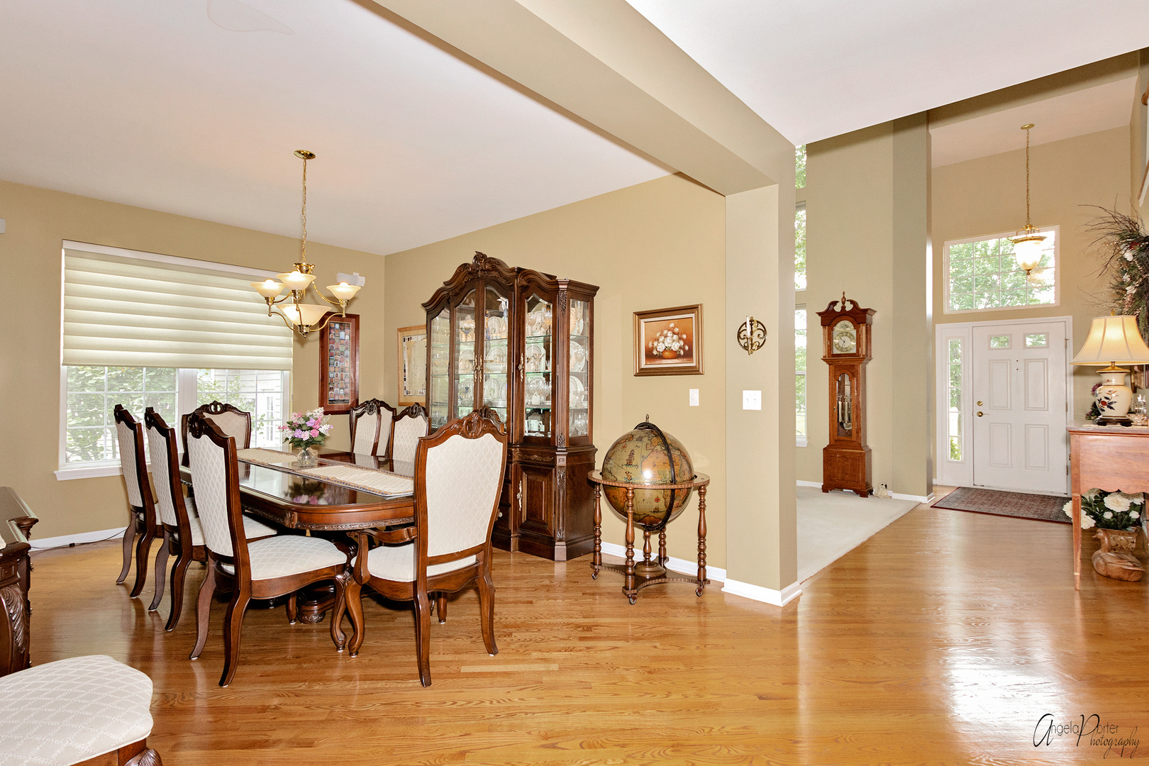 398 Sterling Circle Cary, IL 60013 - Photo 8 of 68 a dining room with wooden floor a chandelier a glass table and chairs