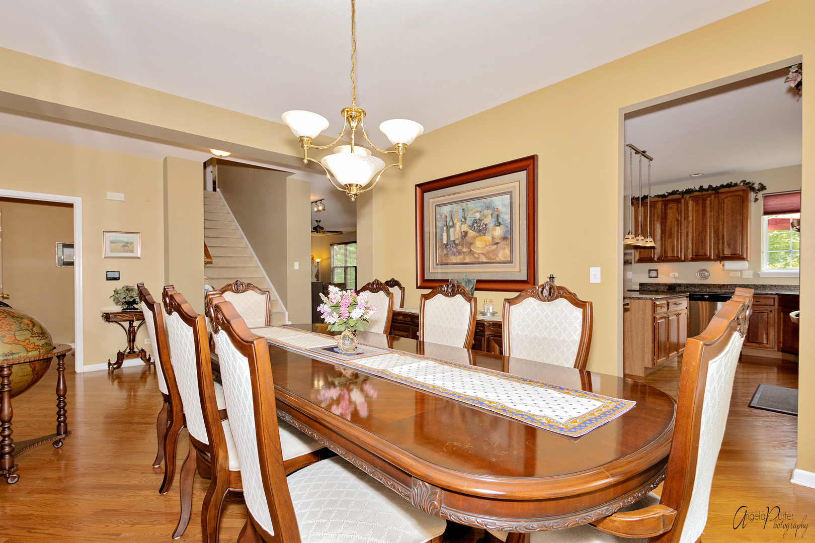 398 Sterling Circle Cary, IL 60013 - Photo 9 of 68 a dining room with furniture a chandelier and wooden floor