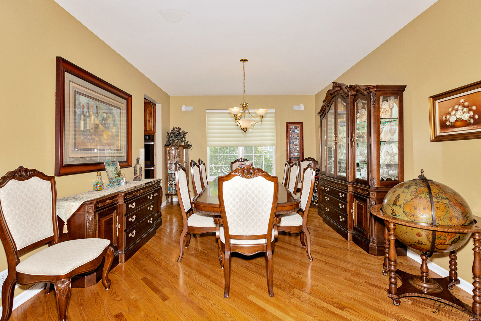 398 Sterling Circle Cary, IL 60013 - Photo 10 of 68 a dining room with furniture a chandelier and wooden floor