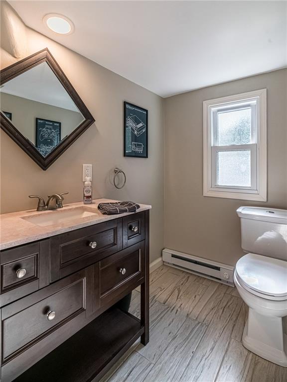 2814 Graham Boulevard Pittsburgh, PA 15235 - Photo 21 of 25 a bathroom with a toilet sink and mirror