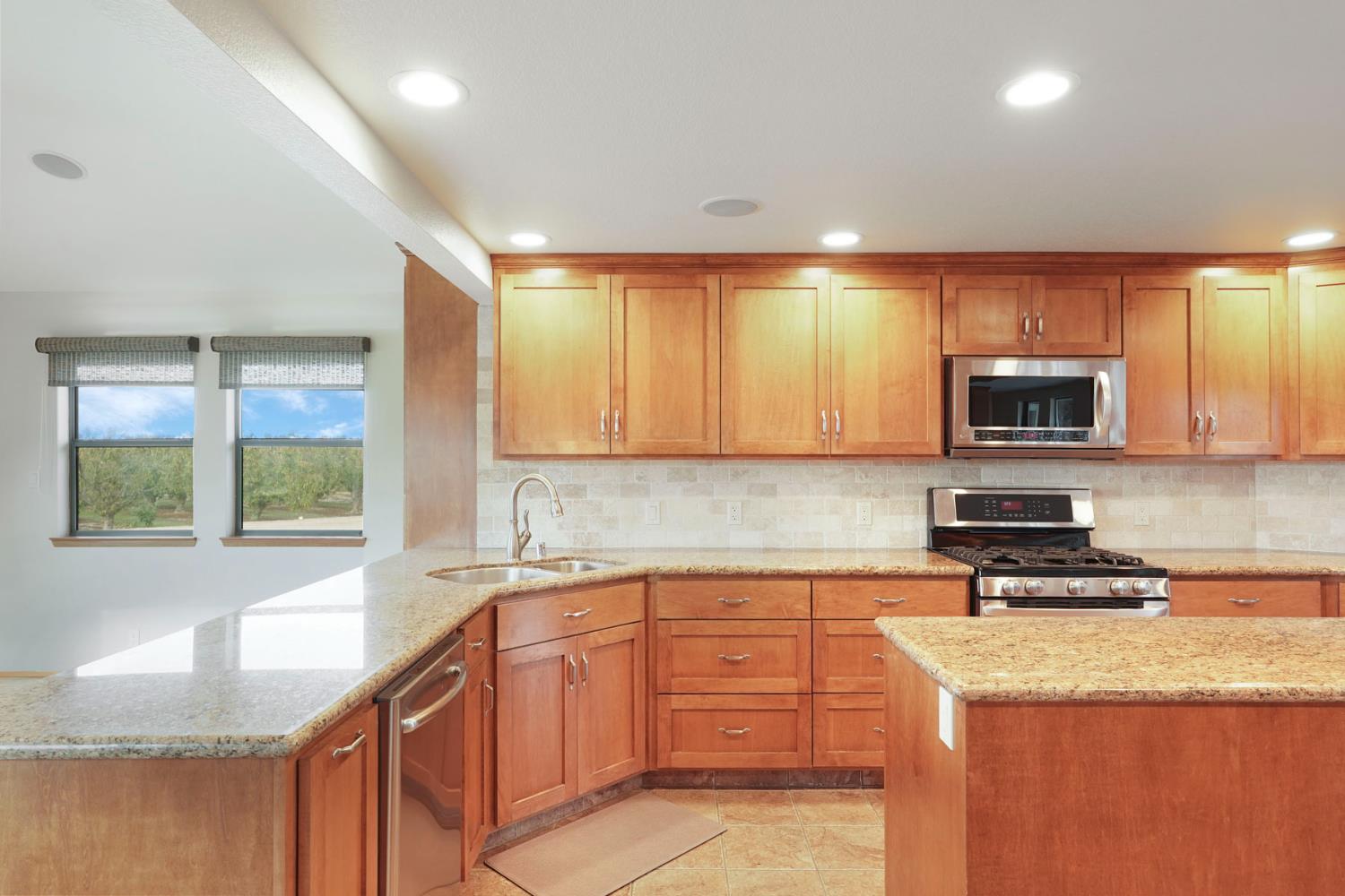 22022 South 99 Frontage Road Ripon, CA 95366 - Photo 11 of 46 a kitchen with granite countertop a sink a stove top oven a counter space and cabinets