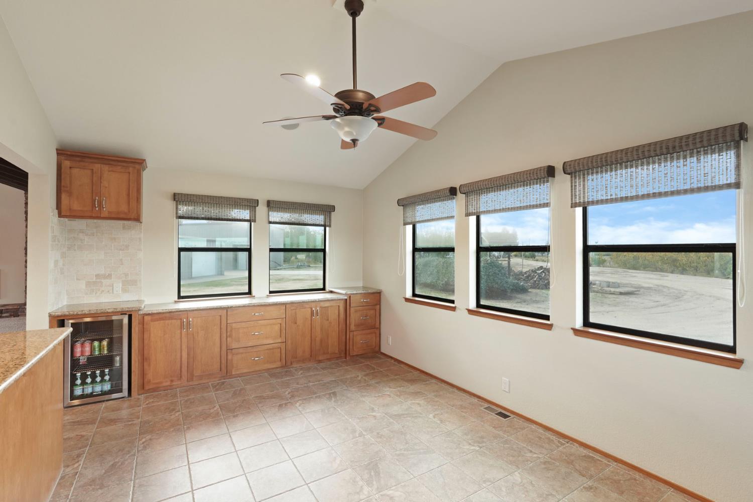 22022 South 99 Frontage Road Ripon, CA 95366 - Photo 12 of 46 a large white kitchen with granite countertop a large window and a sink