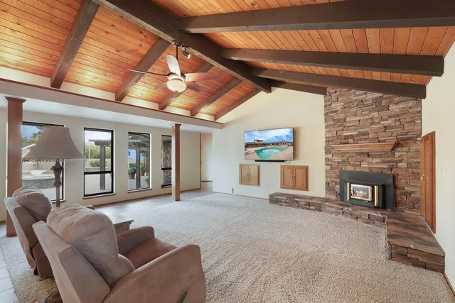 a living room with furniture a fireplace and a table