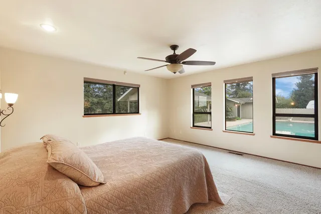 a bedroom with a large bed and a window