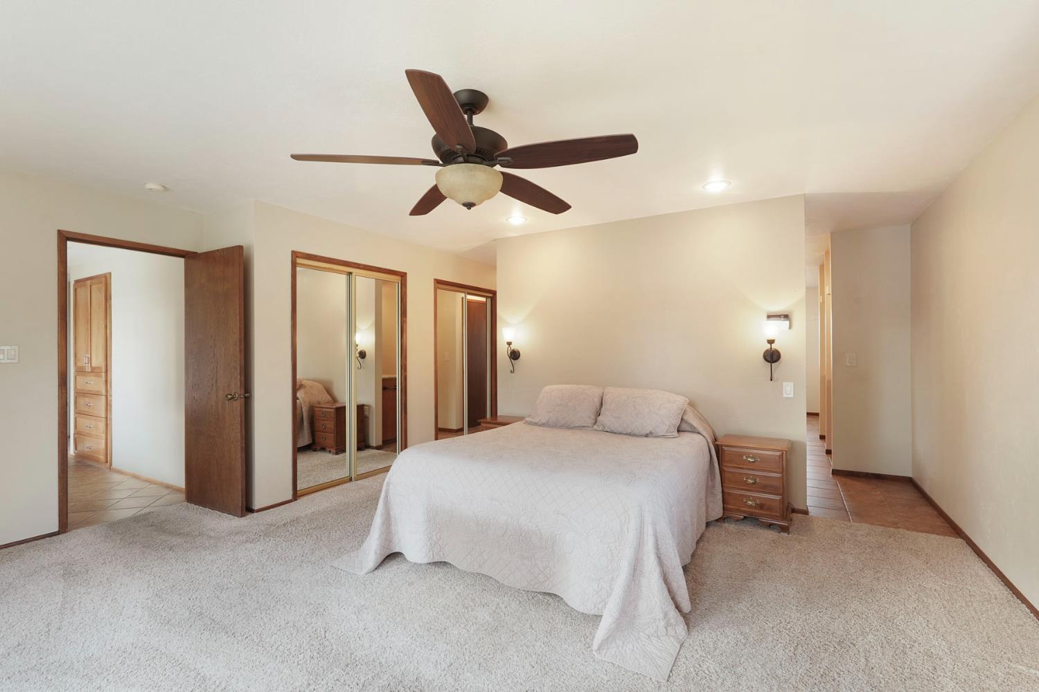 22022 South 99 Frontage Road Ripon, CA 95366 - Photo 19 of 46 a bedroom with a bed and a ceiling fan