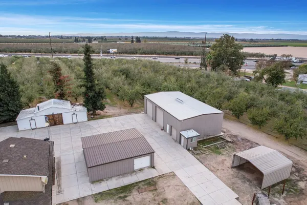 an aerial view of a house with a yard basket ball court and outdoor seating