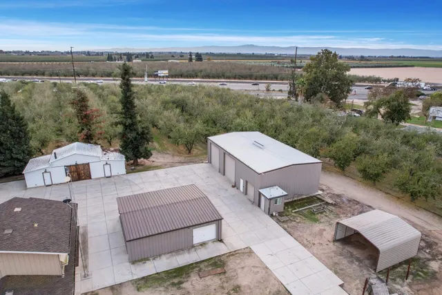 an aerial view of a house with a yard basket ball court and outdoor seating