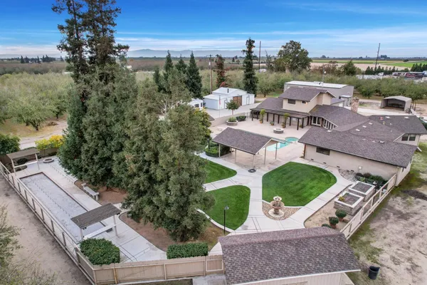 an aerial view of a house with garden space and street view