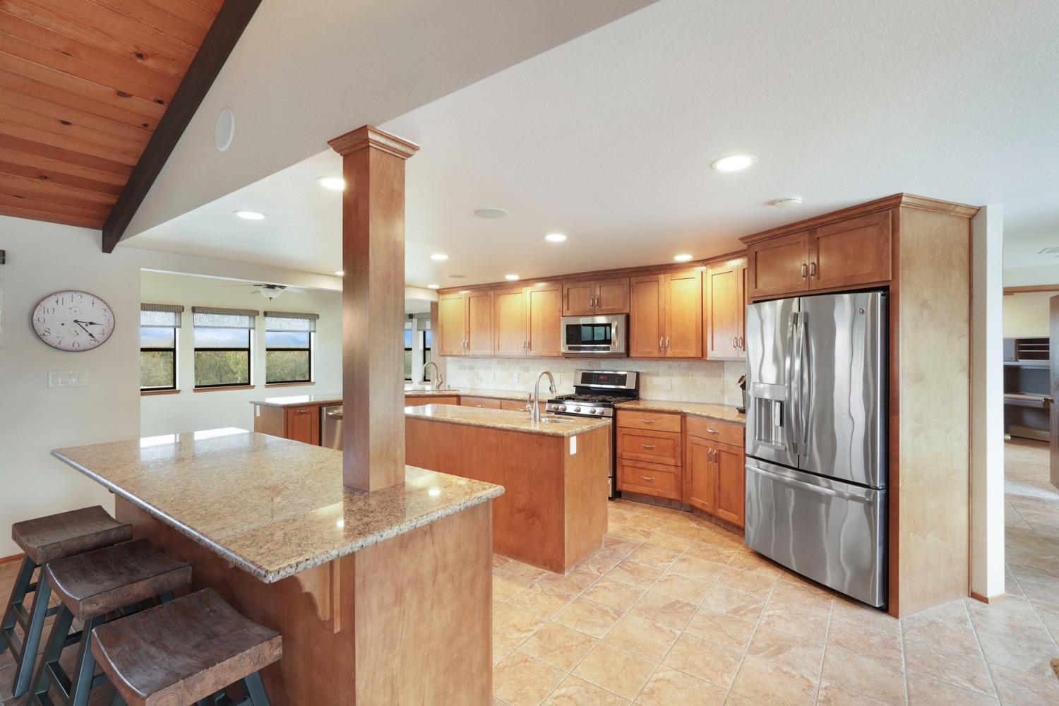 22022 South 99 Frontage Road Ripon, CA 95366 - Photo 8 of 46 a kitchen with stainless steel appliances granite countertop a refrigerator a stove and a sink with granite countertops