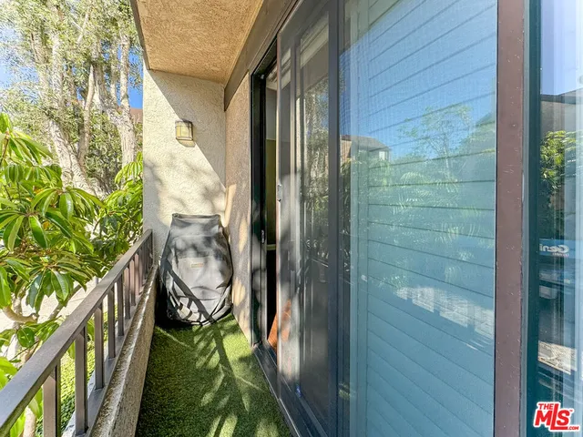 a balcony with view of swimming pool