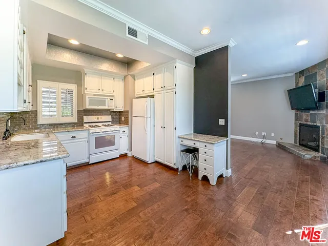 a view of kitchen with cabinets and wooden floor