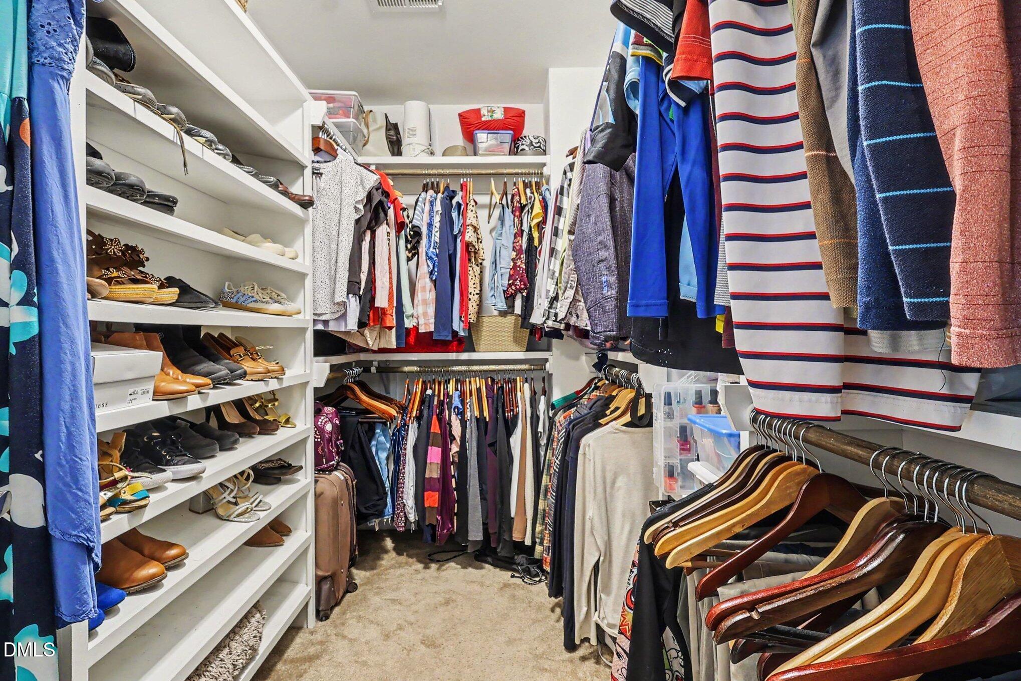 4366 Auburn Hills Drive Raleigh, NC 27616 - Photo 19 of 40 a view of walk in closet with clothes and shoes