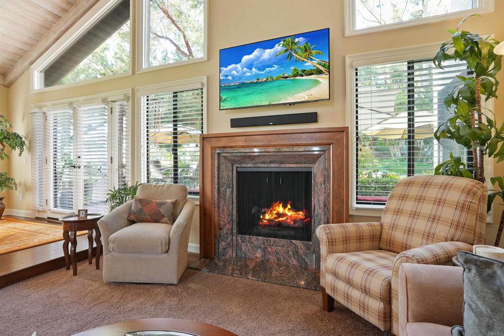 1320 Sun Valley Road Solana Beach, CA 92075 - Photo 13 of 36 a living room with furniture a flat screen tv and a fireplace