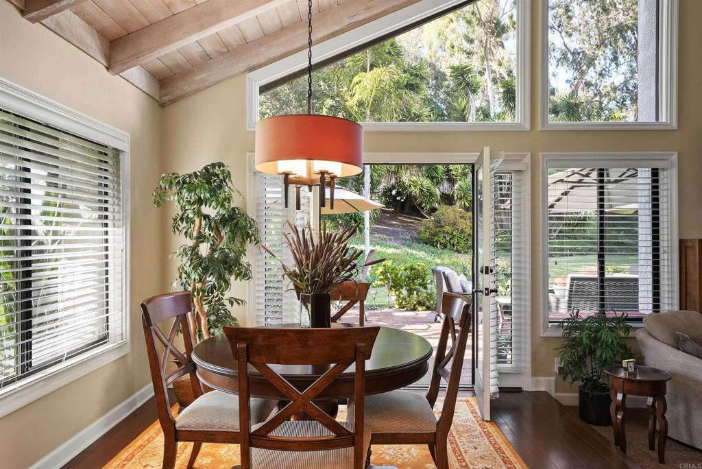 1320 Sun Valley Road Solana Beach, CA 92075 - Photo 15 of 36 a dining room with furniture potted plants and wooden floor