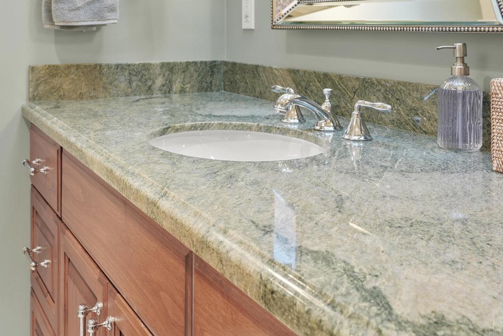 1320 Sun Valley Road Solana Beach, CA 92075 - Photo 29 of 36 a bathroom with a sink and a mirror