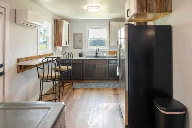 a kitchen with stainless steel appliances granite countertop a refrigerator a stove and a wooden cabinets