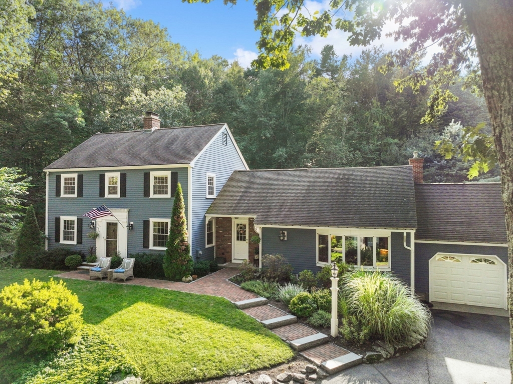 a aerial view of a house with a yard table and chairs