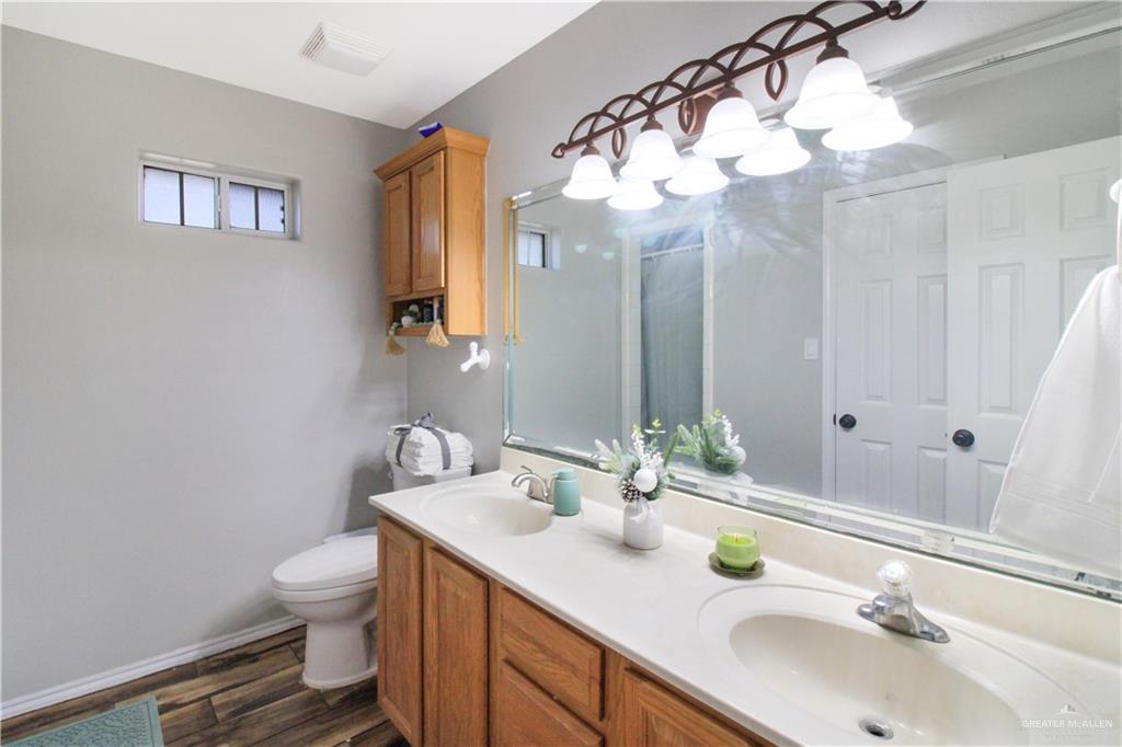 21412 Rusty Lane Harlingen, TX 78552 - Photo 13 of 35 a bathroom with a sink and a mirror